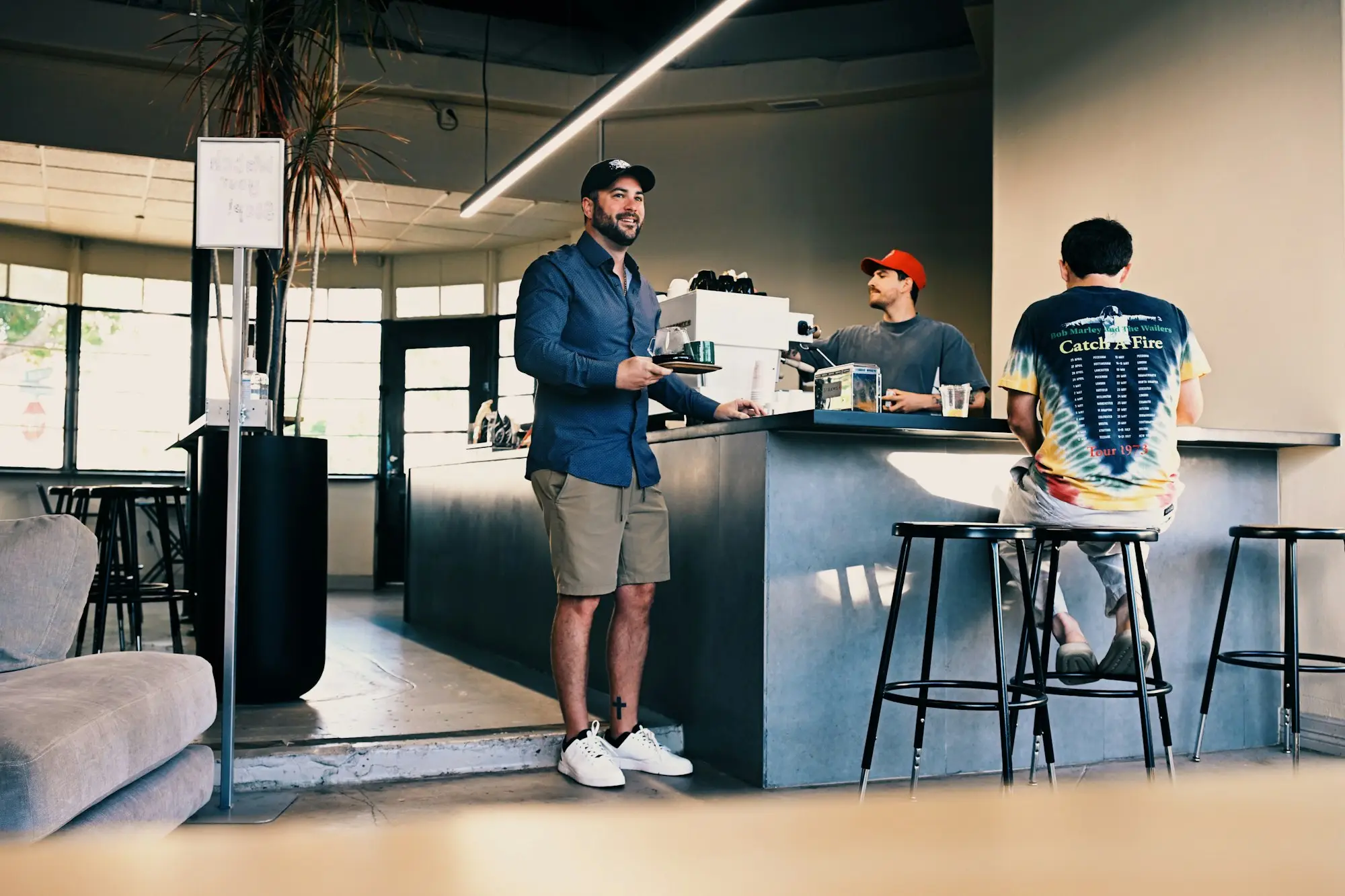 Barista serving customers at a cafe counter
