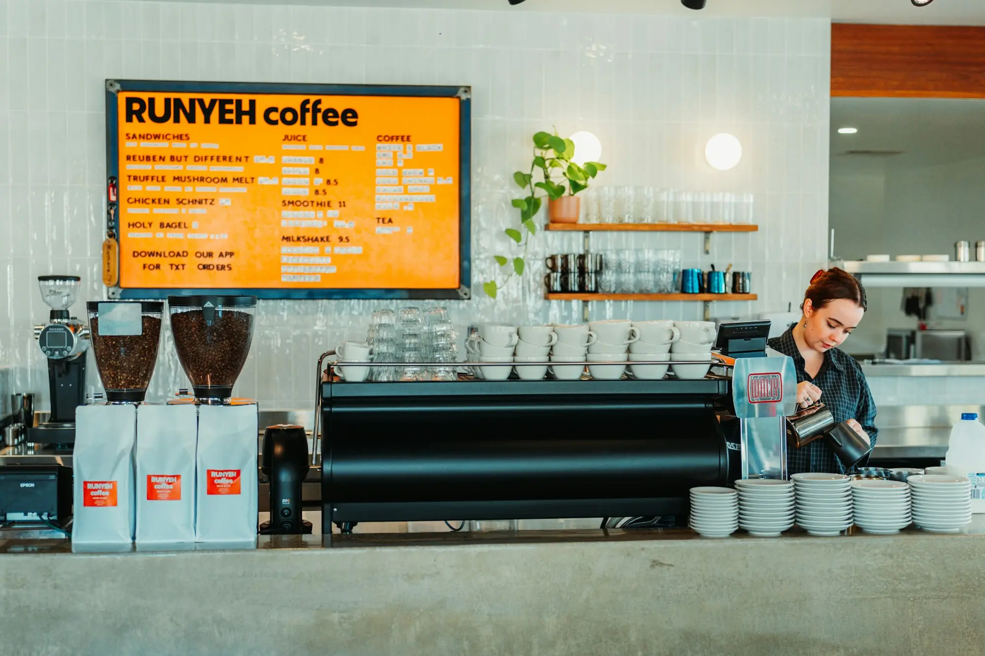 Barista at the espresso machine in a Perth specialty coffee shop